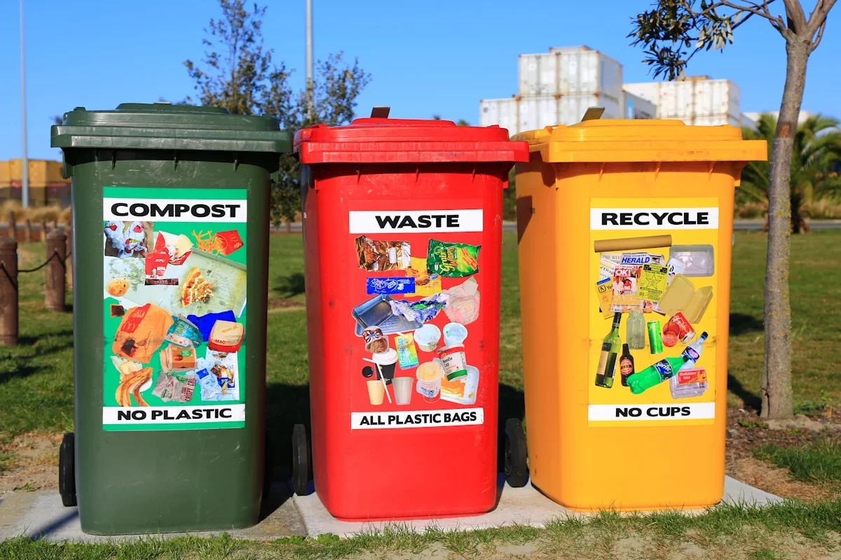 Color-coded recycling and waste bins lined up on an Israeli residential street