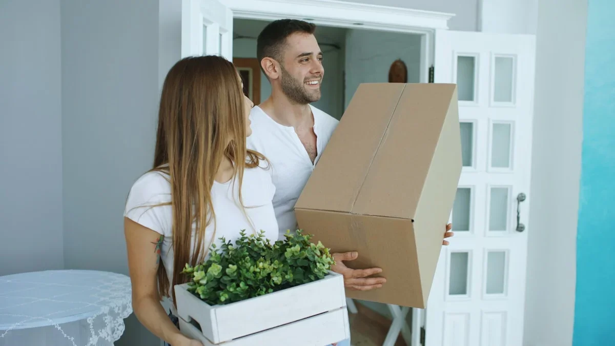 A new immigrant carrying moving boxes into an apartment building in Israel
